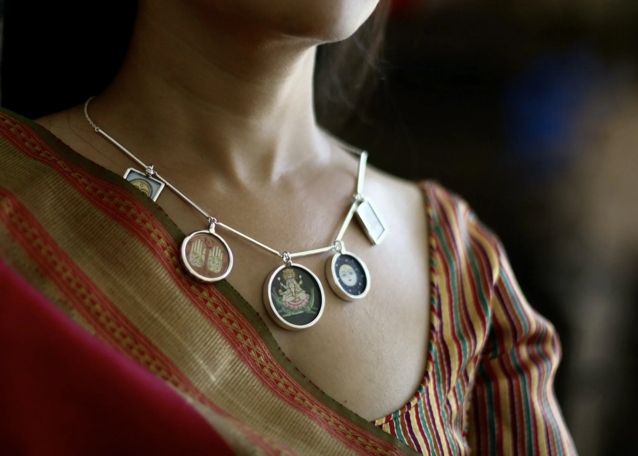 Dramatic, conversation-starting, linked necklace with miniature painting pendants