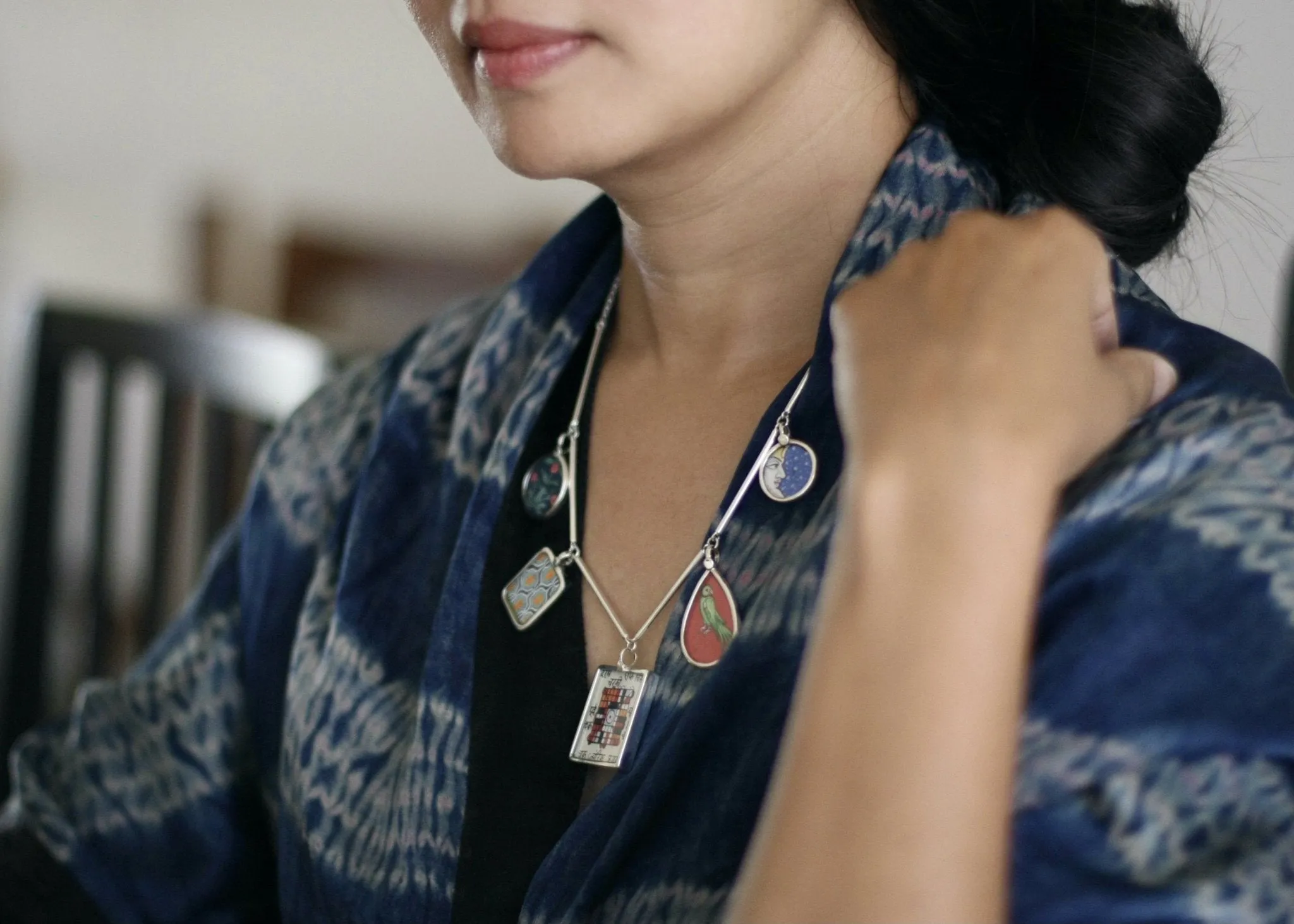 Dramatic, conversation-starting, linked necklace with miniature painting pendants