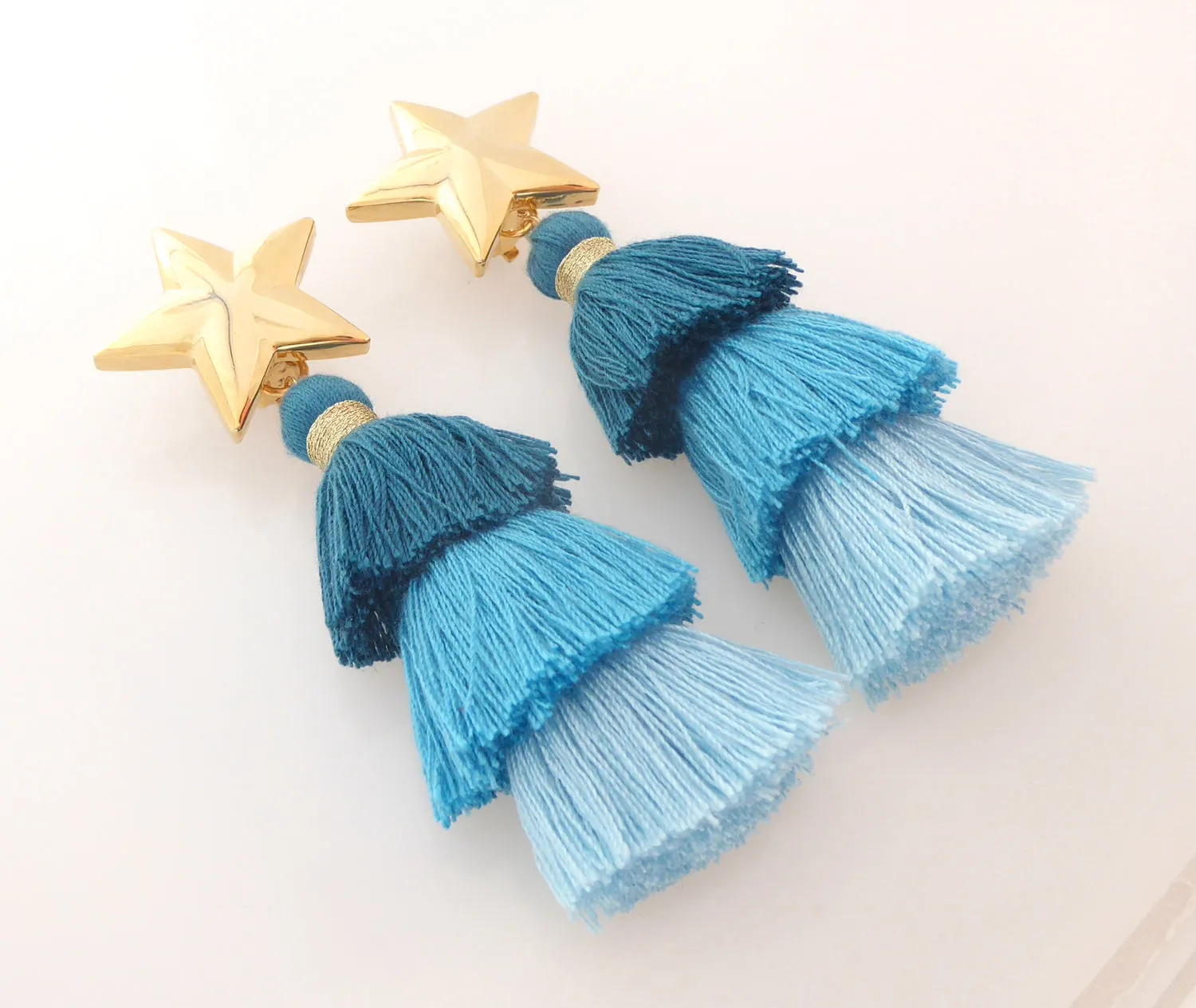 Gold star and teal tassel earrings
