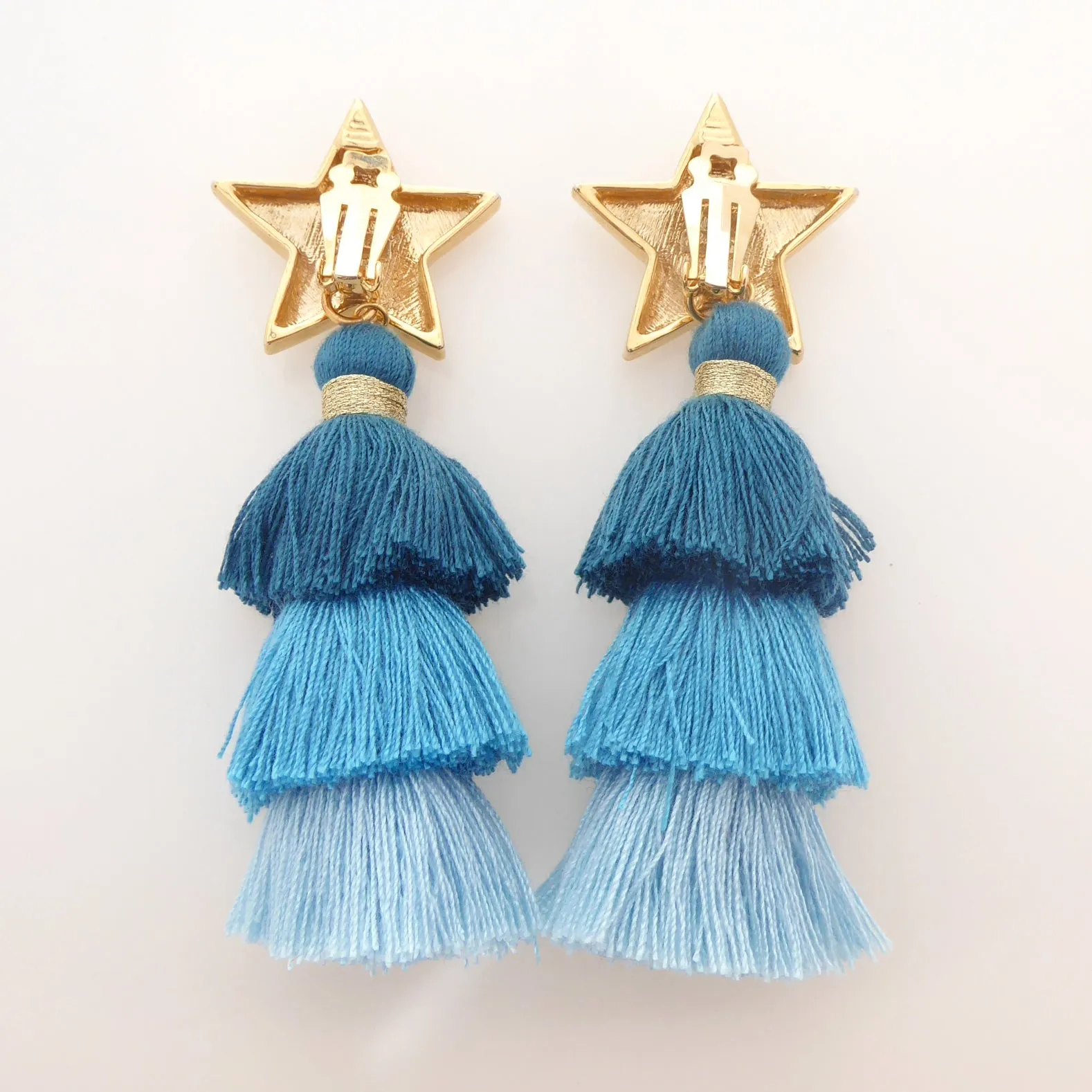 Gold star and teal tassel earrings